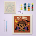 Nuts About Halloween canvas before and after punching, with the threads and tools