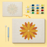 Orange Dahlia canvas before and after punching, with the threads and tools