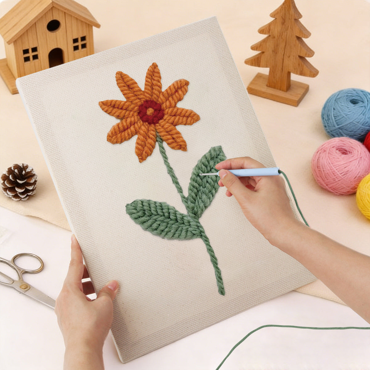 Punching the Orange Daisy design with the punch needle