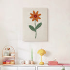 Finished Orange Daisy punch needle canvas on a wall