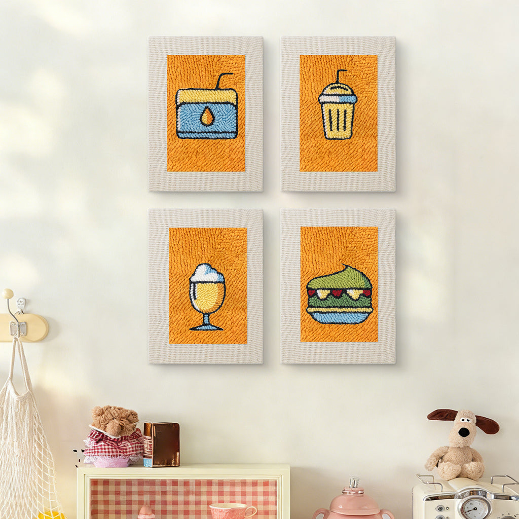 The four Orange Drink Stand mini canvases on a wall above a shelf