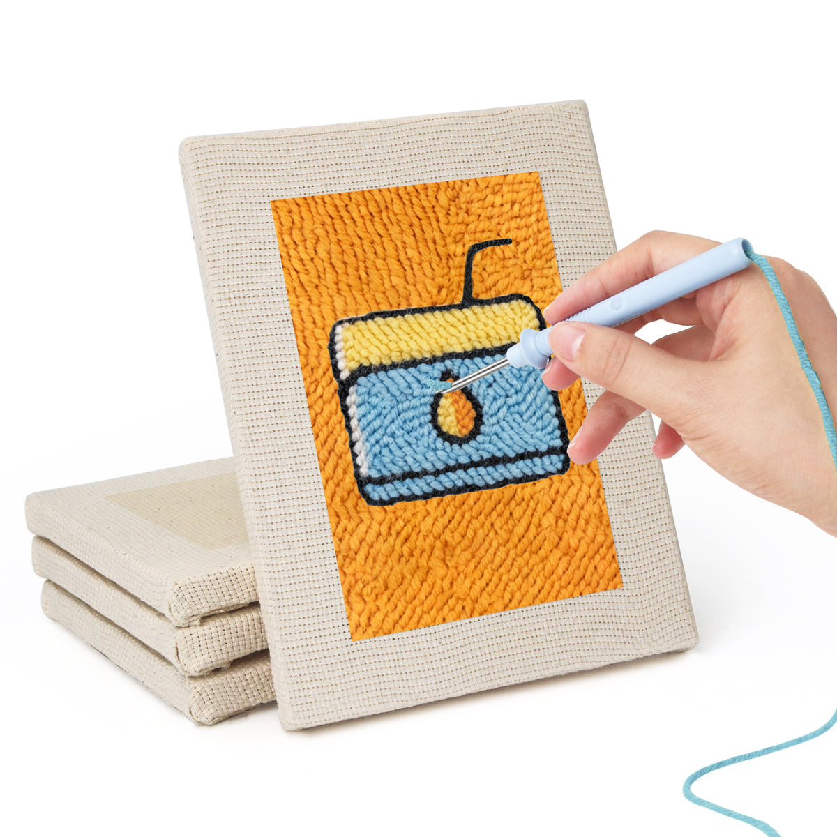 Hand punching one of the Orange Drink Stand mini canvases