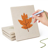 Hand punching one of the Orange Maple Leaves mini canvases
