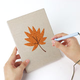 Punching a Orange Maple Leaves mini canvas with the punch needle