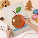 Punching the Orange on Blue design with the punch needle