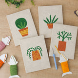 The four finished Orange Pot Greens mini canvases laid out on a table