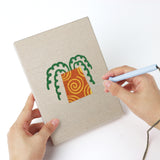 Punching a Orange Pot Greens mini canvas with the punch needle