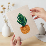 Hand holding a finished Orange Pot Plants mini canvas