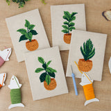 The four finished Orange Pot Plants mini canvases laid out on a table