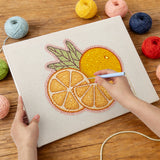 Punching the Orange Slices design with the punch needle
