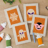 The four finished Orange Spiderweb mini canvases laid out on a table