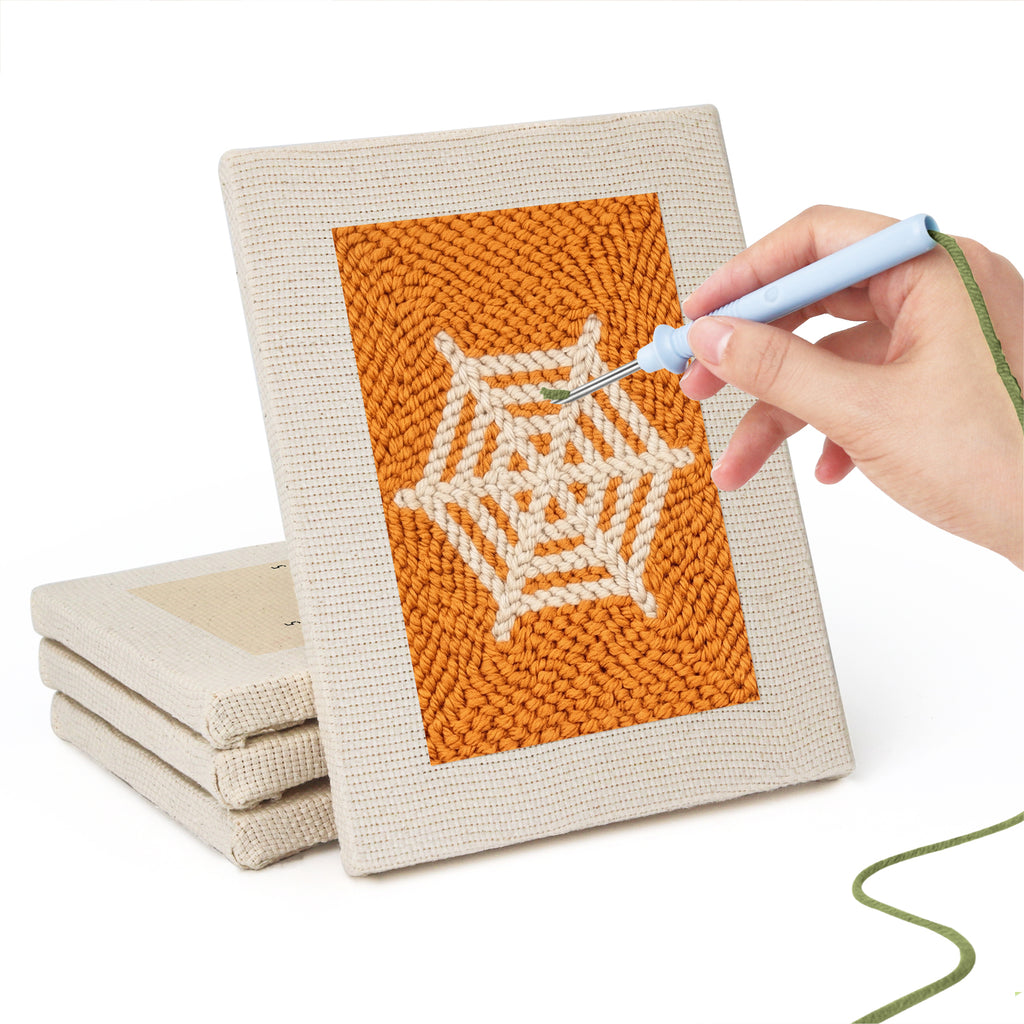 Hand punching one of the Orange Spiderweb mini canvases