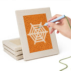 Hand punching one of the Orange Spiderweb mini canvases