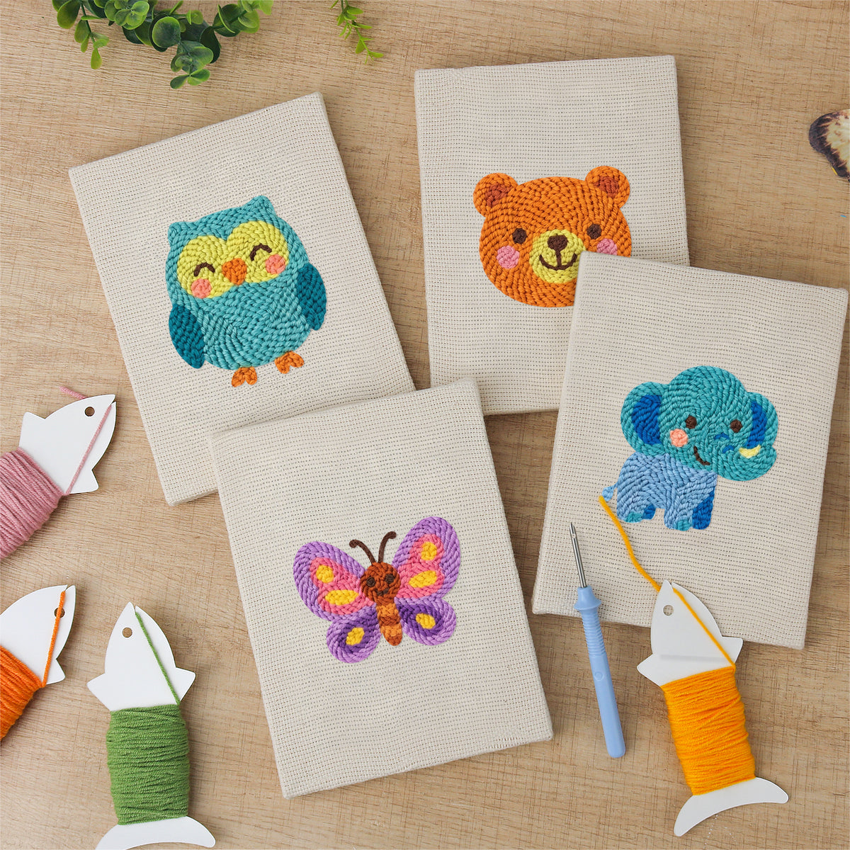 The four finished Owl and Butterfly mini canvases laid out on a table