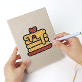 Punching a Pancake Stacks mini canvas with the punch needle