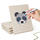 Hand punching one of the Panda and Cat mini canvases