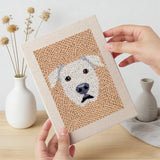 Hand holding a finished Panda and Labrador mini canvas