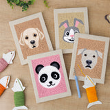 The four finished Panda and Labrador mini canvases laid out on a table