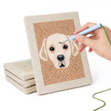 Hand punching one of the Panda and Labrador mini canvases