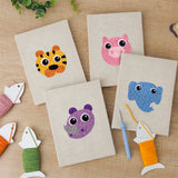 The four finished Pastel Safari Faces mini canvases laid out on a table
