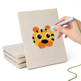 Hand punching one of the Pastel Safari Faces mini canvases