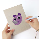 Punching a Pastel Safari Faces mini canvas with the punch needle