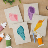 The four finished Pastel Seashells mini canvases laid out on a table