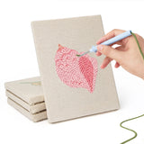 Hand punching one of the Pastel Seashells mini canvases
