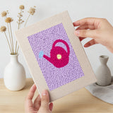 Hand holding a finished Pastel Watering Cans mini canvas