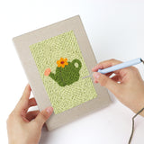 Punching a Pastel Watering Cans mini canvas with the punch needle