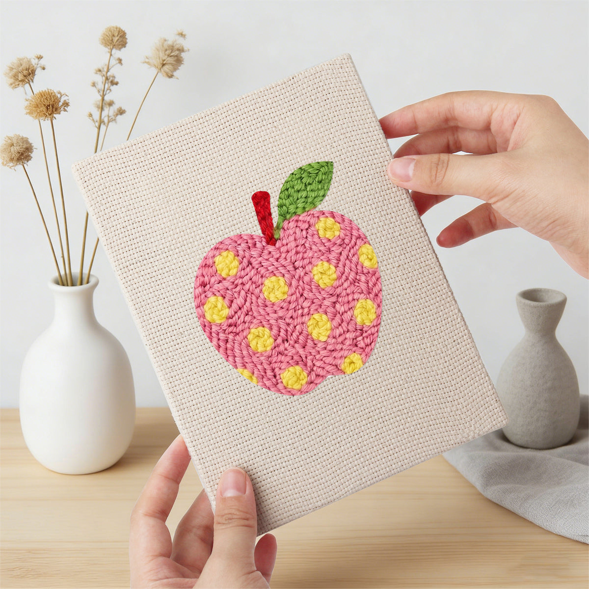 Hand holding a finished Patterned Apples mini canvas
