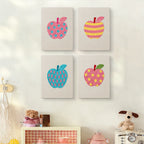 The four Patterned Apples mini canvases on a wall above a shelf
