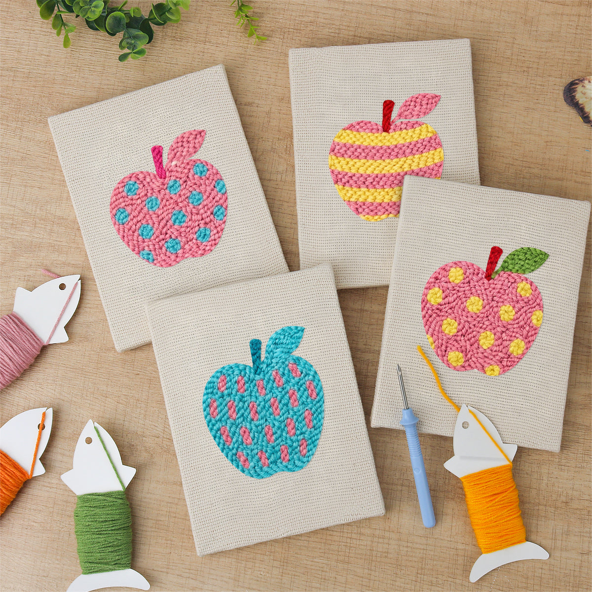 The four finished Patterned Apples mini canvases laid out on a table