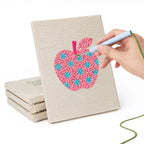 Hand punching one of the Patterned Apples mini canvases