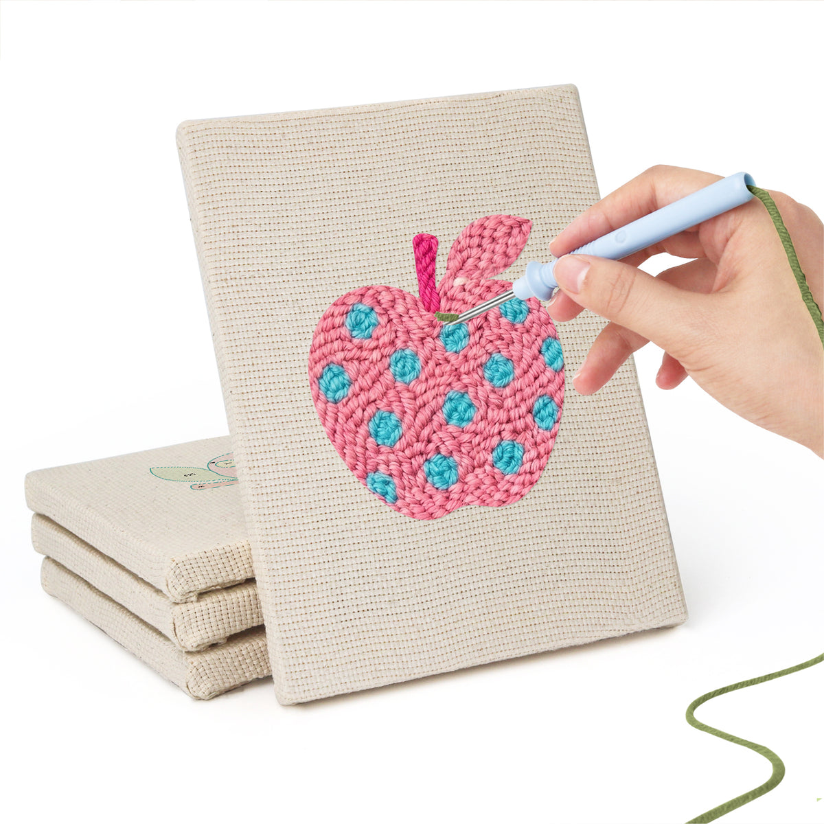 Hand punching one of the Patterned Apples mini canvases