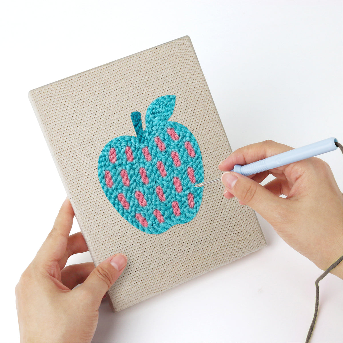 Punching a Patterned Apples mini canvas with the punch needle