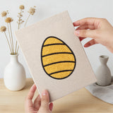 Hand holding a finished Patterned Easter Eggs mini canvas