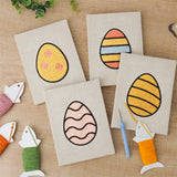 The four finished Patterned Easter Eggs mini canvases laid out on a table