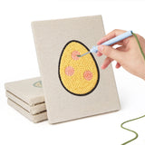 Hand punching one of the Patterned Easter Eggs mini canvases