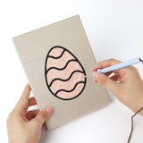 Punching a Patterned Easter Eggs mini canvas with the punch needle