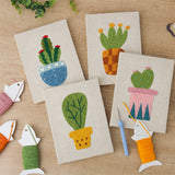 The four finished Patterned Pot Cacti mini canvases laid out on a table