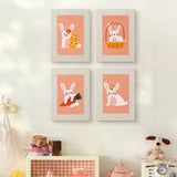 The four Peach Easter Bunnies mini canvases on a wall above a shelf