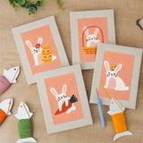 The four finished Peach Easter Bunnies mini canvases laid out on a table