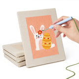 Hand punching one of the Peach Easter Bunnies mini canvases