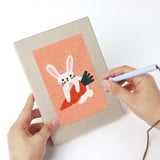 Punching a Peach Easter Bunnies mini canvas with the punch needle