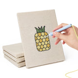 Hand punching one of the Pear Peach Pineapple mini canvases