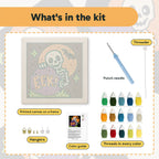 What is in the Peekaboo Skeleton kit: printed canvas, punch needle, threader, threads, color guide and hangers