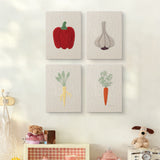 The four Pepper and Garlic mini canvases on a wall above a shelf