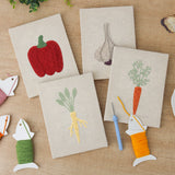 The four finished Pepper and Garlic mini canvases laid out on a table