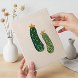 Hand holding a finished Peppers and Zucchini mini canvas